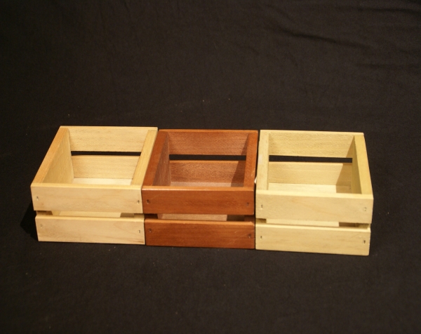 Three mini open top custom wood crates side by side. The middle crate is stained.